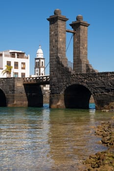 Bridge to the historic fort of Arrecife on a sunny day with blue sky, Lanzarote, Spain