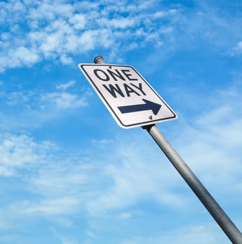 One way road sign on blue sky background