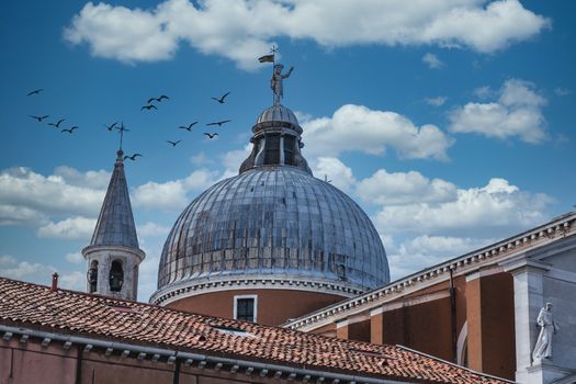 The Dome of Old Church in Venice Beyond Red Tile Roof