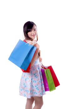 happy excited woman standing and holding colorful shopping bags isolated on a white background.