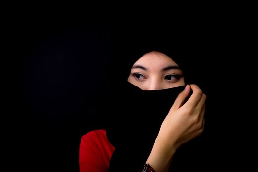 beautiful mysterious young woman wearing scarf close up.