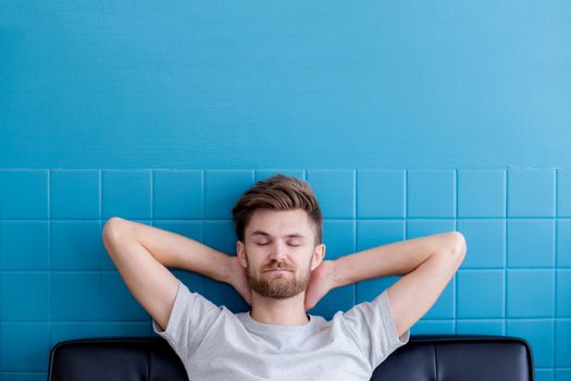 man yawning and going asleep in his  living room