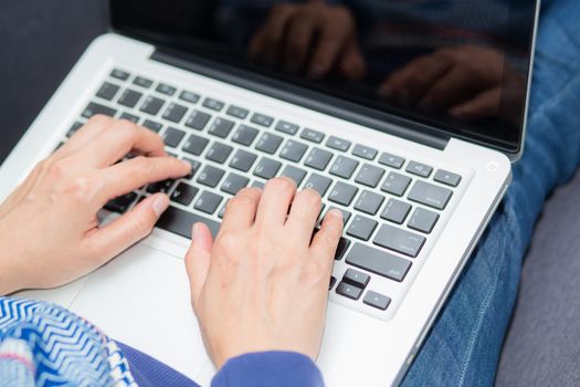 Closeup computer notebook on sofa with asian woman for work in lifestyle of woman concept