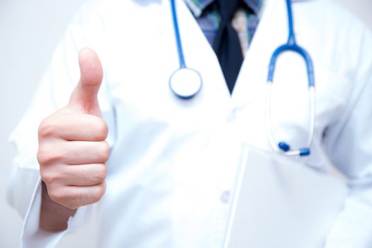 close up of male doctor hand showing thumbs up.