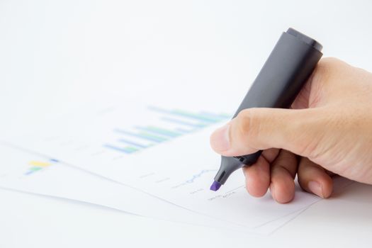 Close-up of male hand holding marker over business document.