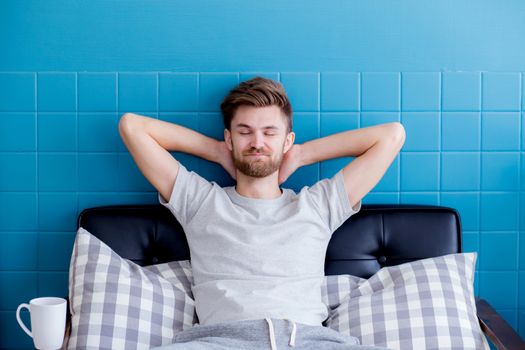 man yawning and going asleep in his  living room