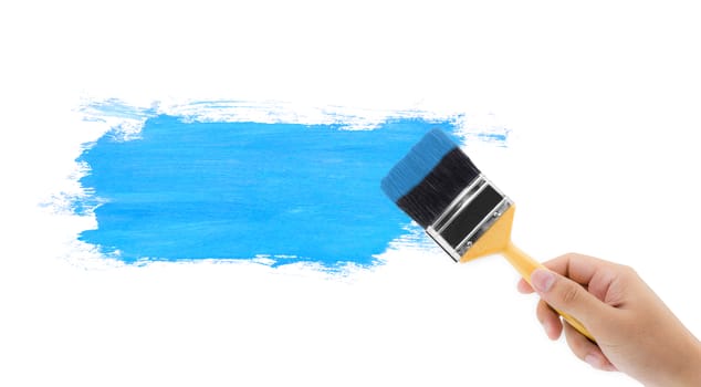 Hand hold brush painting blue with white copy space.