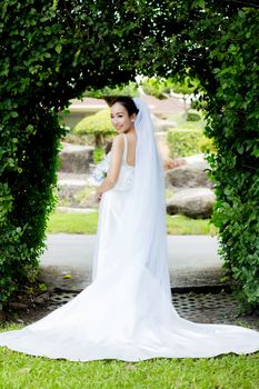 beautiful young woman on wedding day in white dress in the garden - Female portrait in the park - Selective focus.