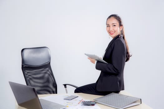 businesswoman looking tablet with sitting table in office on white background.
