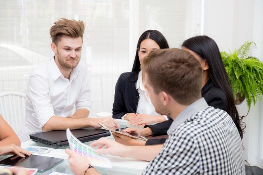 Group of business people brainstorming together in the meeting room.