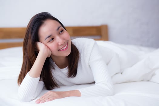 woman beautiful smiling woman portrait wake up early morning after sleeping and lying in bed.