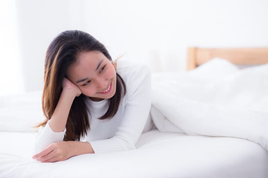 woman beautiful smiling woman portrait wake up early morning after sleeping and lying in bed.