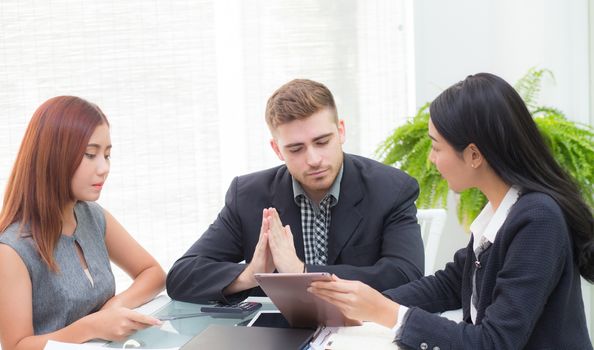 young business people making meeting and looking at tablet for analyzing marketing working at office on desk.