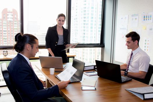 businesswoman presentation to a group in meeting.