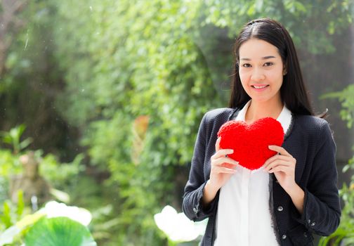 Red heart in businesswoman hand - Asian woman with hope concept.