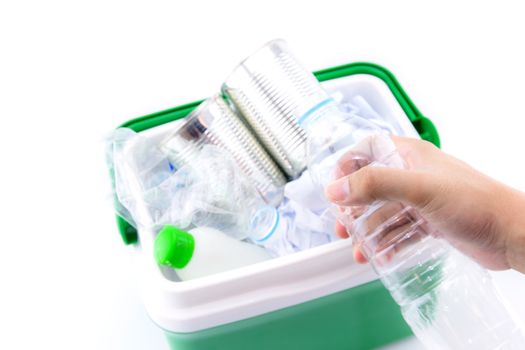 A recycle bin with plastic bottles, paper and other plastic items  and bottle on hand isolated on white background.