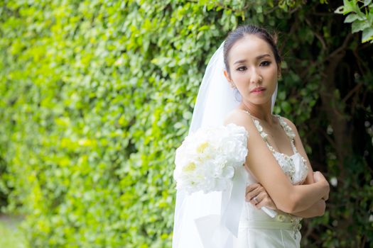 beautiful young woman on wedding day in white dress in the tree wall. Female portrait in the park - Selective focus