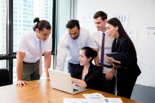 Business team having a meeting using laptop during a meeting and presents.