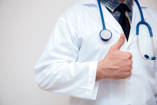 close up of male doctor hand showing thumbs up.