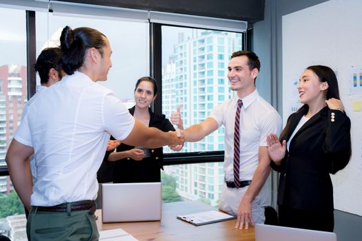 Business people shaking hands, finishing up a meeting.