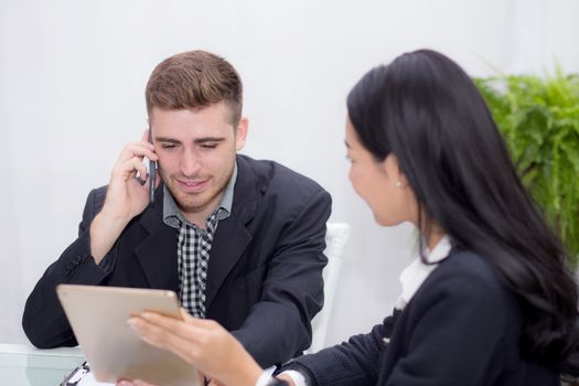 business man and woman people making meeting and looking at tablet for analyzing marketing working at office on desk.