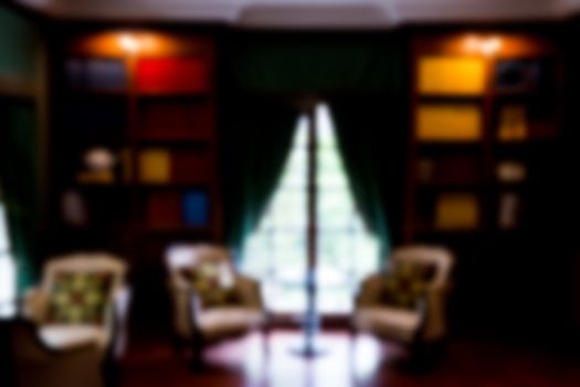 Blurred abstract background of book shelves row and interior of library with textbooks.