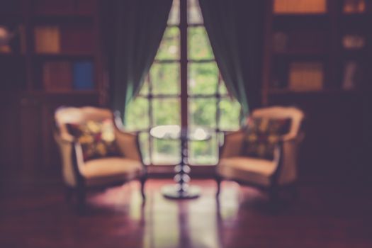 Blurred abstract background of book shelves row and interior of library with textbooks.