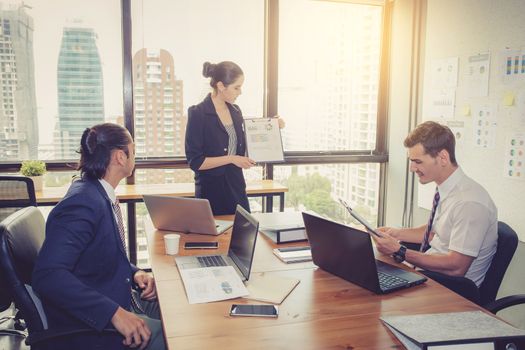 businesswoman presentation to a group in meeting.