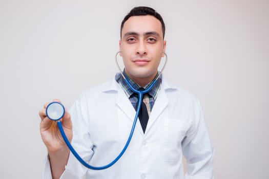 Close-up of male doctor hand stethoscope head ready to examin patient - Healthcare and medical concept.
