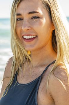 A gorgeous young blonde female enjoys a day at the beach alone