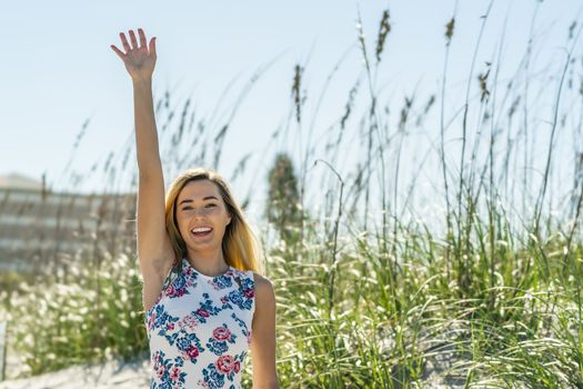 A gorgeous young blonde female enjoys a day at the beach alone