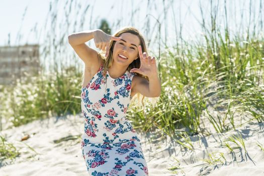 A gorgeous young blonde female enjoys a day at the beach alone
