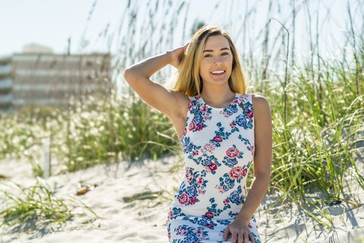 A gorgeous young blonde female enjoys a day at the beach alone