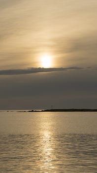 Emotional shot of a bay at sunrise or sunset in backlight with very cloudy sky