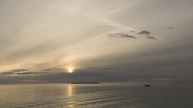 Emotional shot of a bay at sunrise or sunset in backlight with very cloudy sky