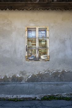 stacks of books in front of an old  window