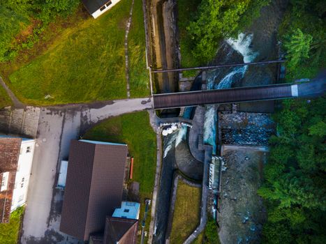 drone shot out in nature of river, bridge and green trees. Höllgrotte Switzerland