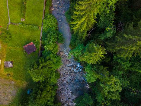 drone shot out in nature of river, bridge and green trees. Höllgrotte Switzerland