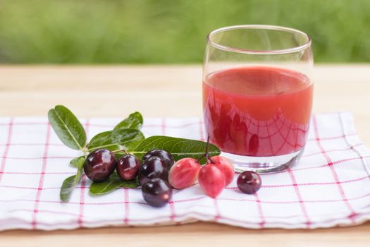 fresh Carissa carandas glass of juice with Carissa carandas fruits and Healthy drinks concept
