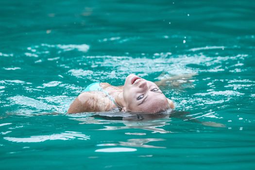 Happy smiling woman swimming in tropical water of Andaman Sea, Thailand