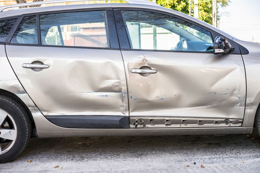 Close-up of dented car doors at car side body after car accident