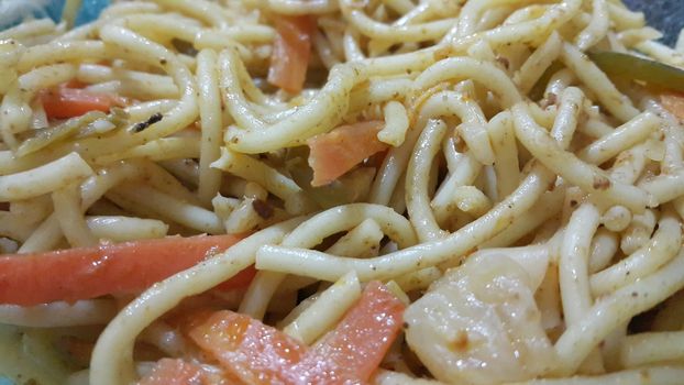 close up view of swirling noodles or spaghetti pasta in a bowl