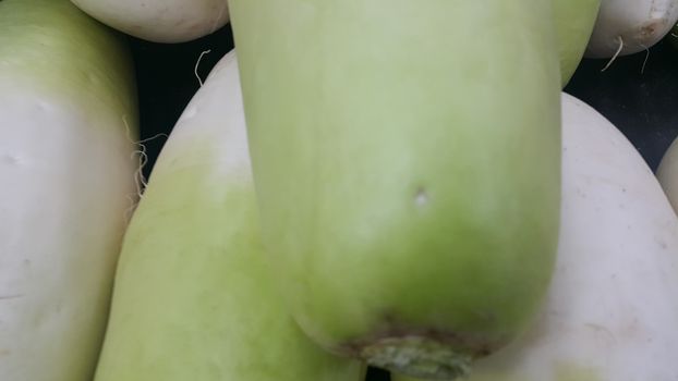 Vegetable background: Large radish pile in supermarket. It is full of vitamins, minerals, fiber and antioxidants.