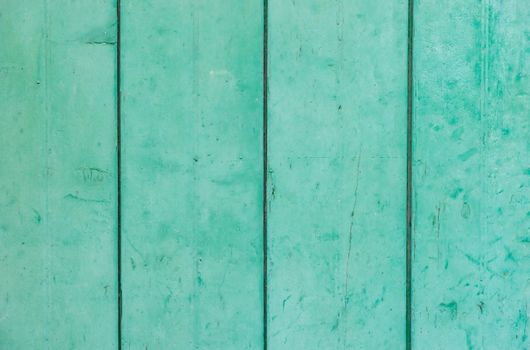 Green colored wooden planks background texture, close-up