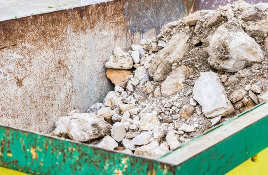 Heap of building rubble in rubbish container