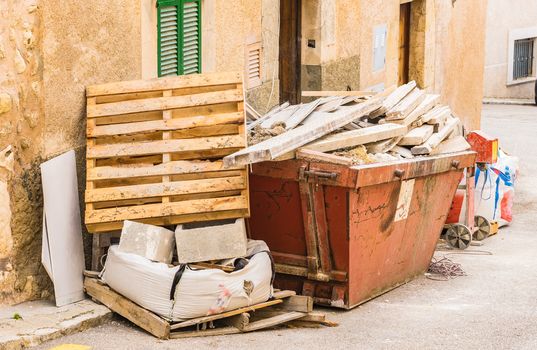 View of construciton site of house improvement and garbage skip container with building rubble