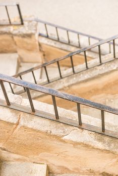 Old stone steps staircase with metal railing