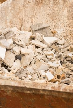Heap of building rubble in rubbish container