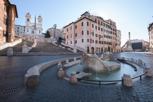 Piazza di Spagna or Spanish Steps, and the monumental staircase leading to church Holy Trinity of the Mounts, with Barcaccia fountain designed by Baroque sculptor Bernini, in Rome, Italy