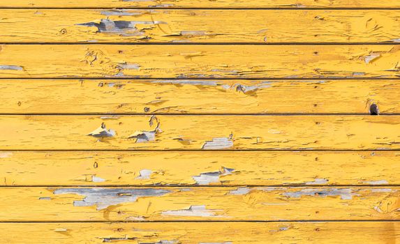 Vintage weathered yellow painted wooden planks background texture